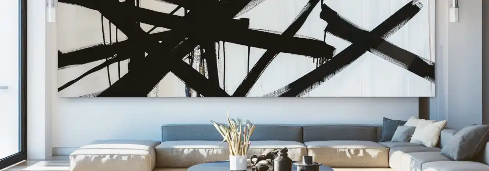 Abstract black-and-white painting above a modern sofa in a bright living room